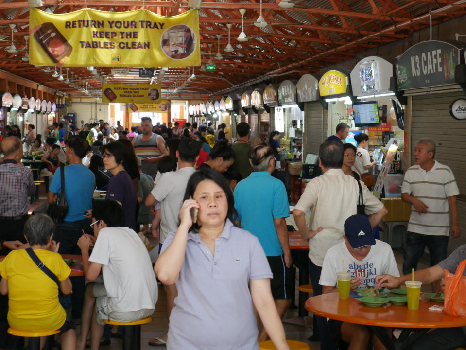 Singapore, Singapore-June 2, 2019: People in the Hawker Center, Chinatown. The government has submitted to inscribe its hawker culture to the UNESCO as the Intangible Cultural Heritage of Humanity.