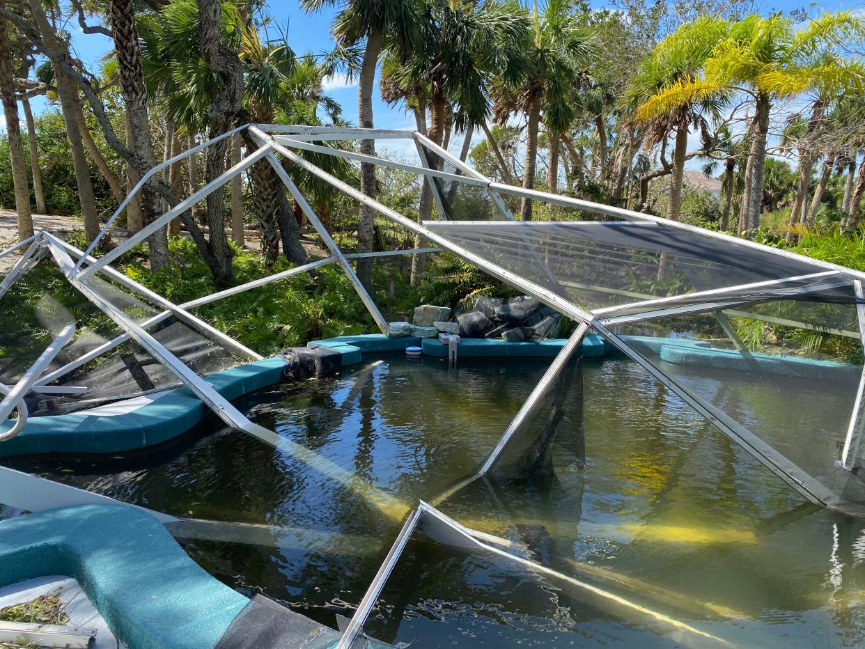 A cage outside the Hermitage Artist Retreat's Palm House was ripped apart during Hurricane Ian.