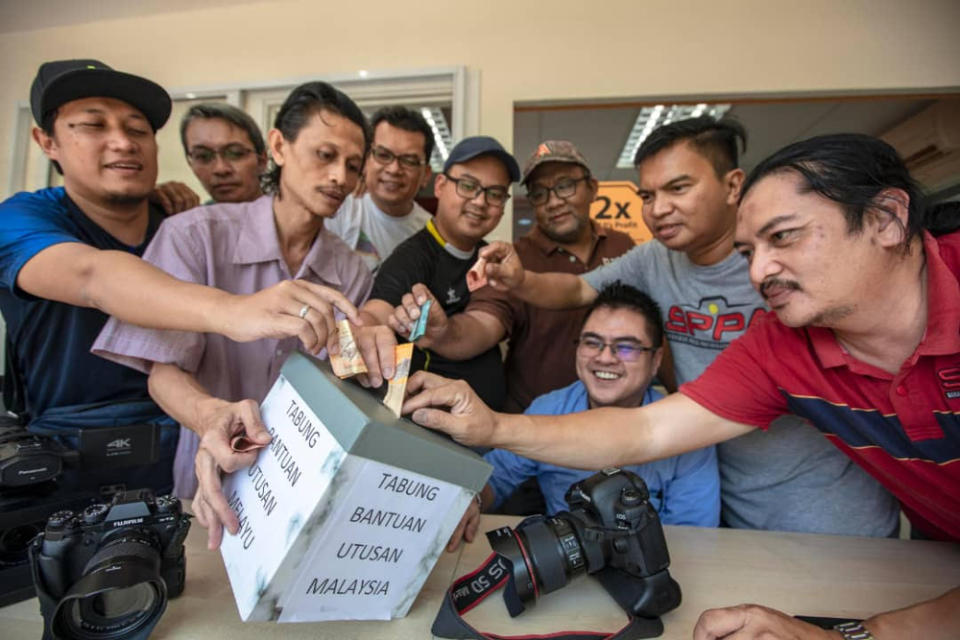 Some media practitioners putting cash donation inside a box to help their colleagues from Utusan Malaysia and Kosmo who are facing hard times, August 21, 2019. — Picture courtesy of Journalists Association of Kuching Division