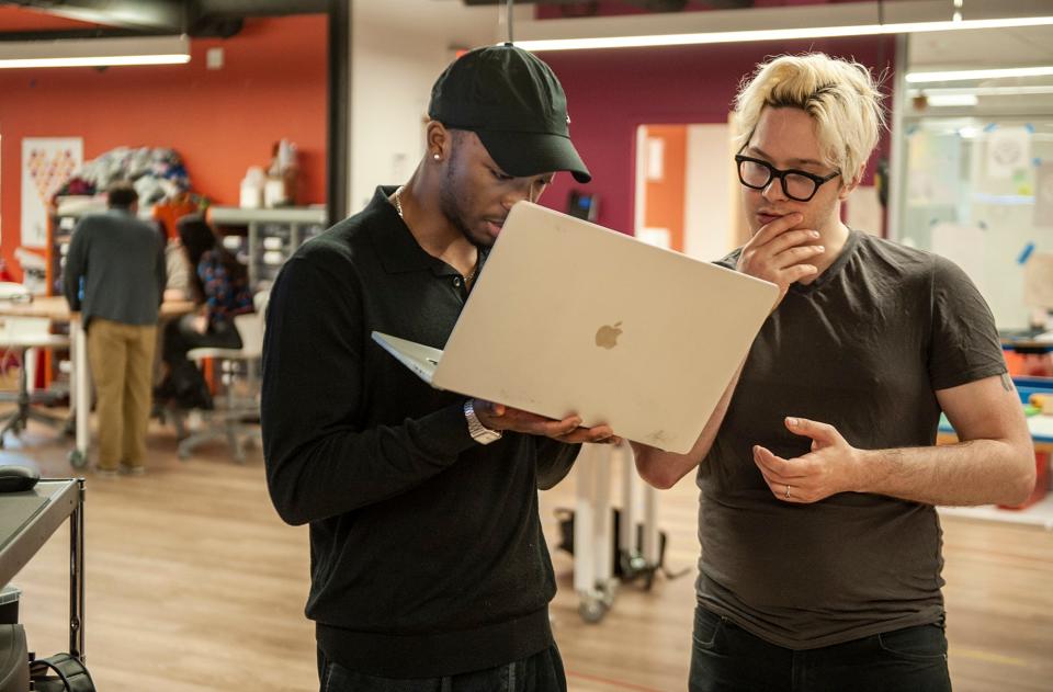 Langston Reid, left, a junior at New England Innovation Academy, consults with materials and methods instructor Nicholas Tamas during a recent class, April 30, 2024.