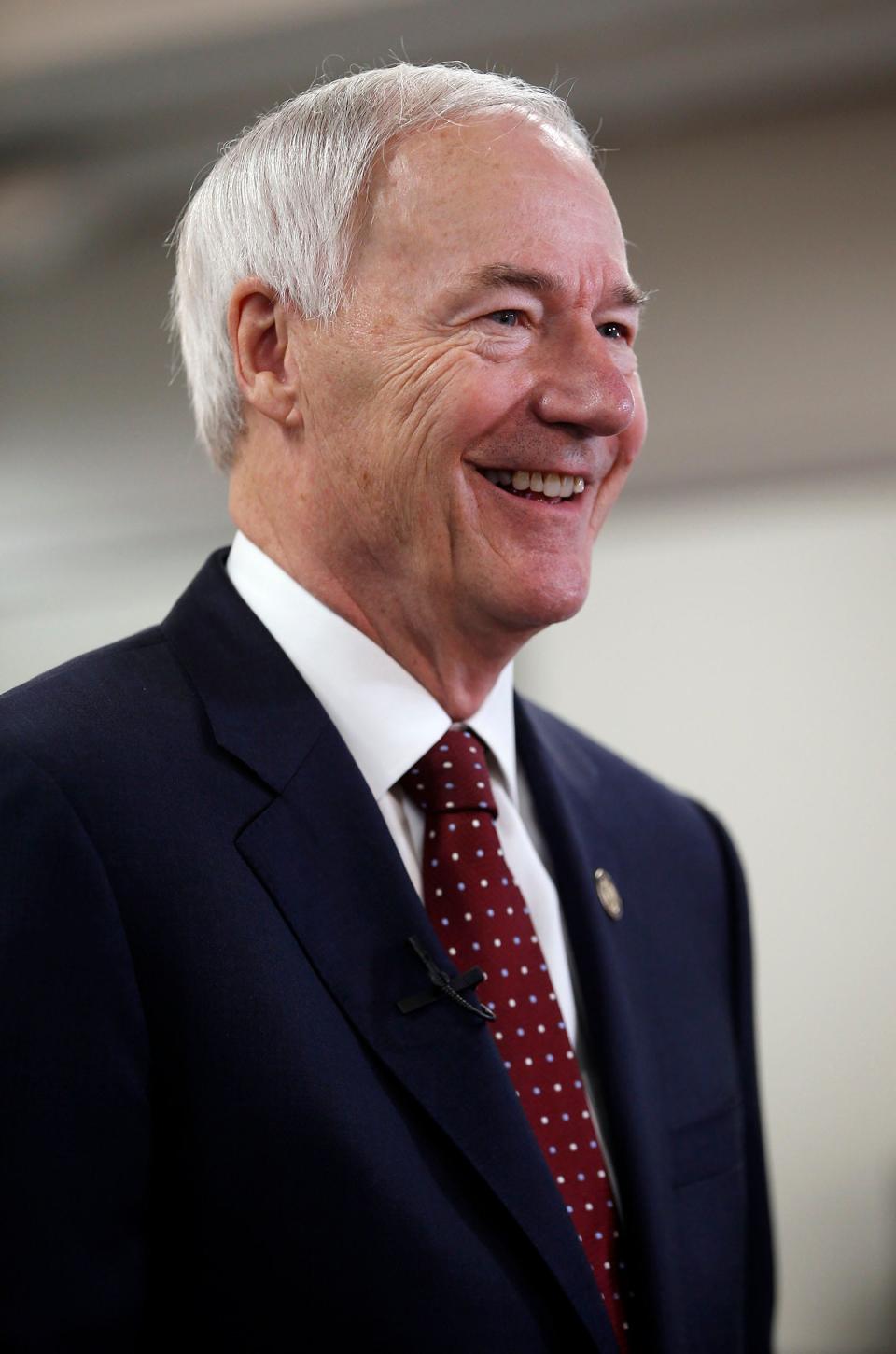 Arkansas Gov. Asa Hutchinson prepares to answer questions from television reporters during the grand opening of the UAFS Center for Ecnomic Development on April 27, 2022, at the Bakery District near downtown Fort Smith. Gov. Hutchinson was given a tour of the facility.