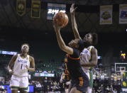Oklahoma State guard Micah Dennis attempts a shot past Baylor center Queen Egbo, right, during the first half of an NCAA college basketball game Wednesday, Jan. 19, 2022, in Waco, Texas. (Rod Aydelotte/Waco Tribune-Herald via AP)