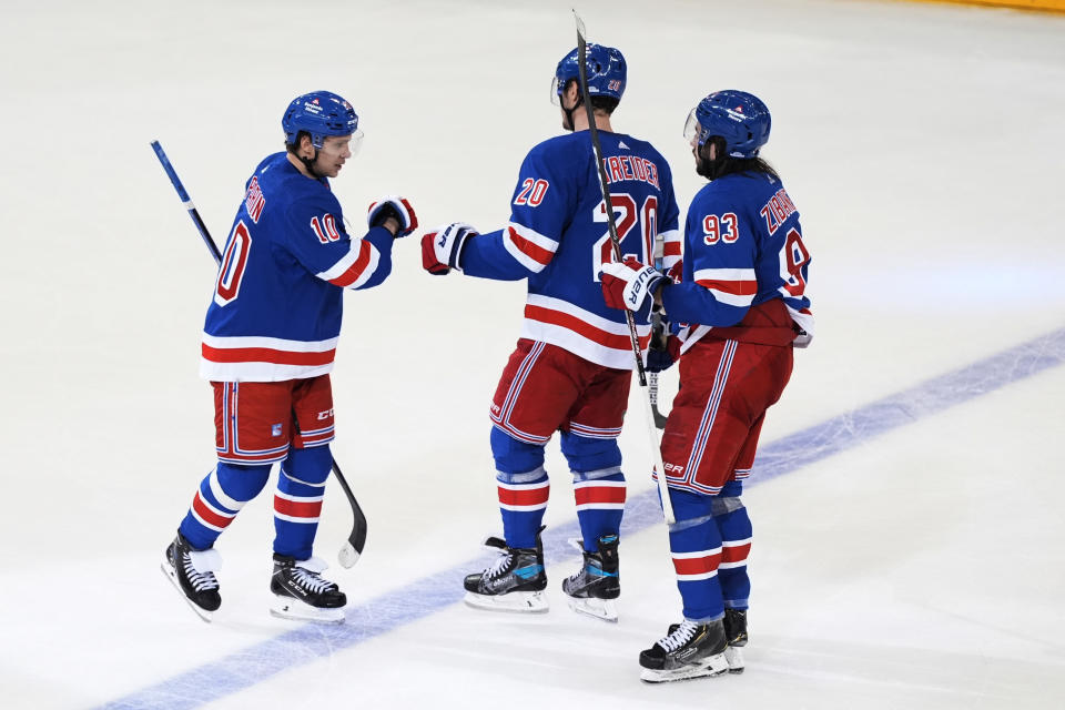 New York Rangers' Artemi Panarin (10) celebrates with Chris Kreider (20) and Mika Zibanejad (93) after scoring an empty-net goal against the Columbus Blue Jackets during the third period of an NHL hockey game Wednesday, Feb. 28, 2024, in New York. The Rangers won 4-1. (AP Photo/Frank Franklin II)