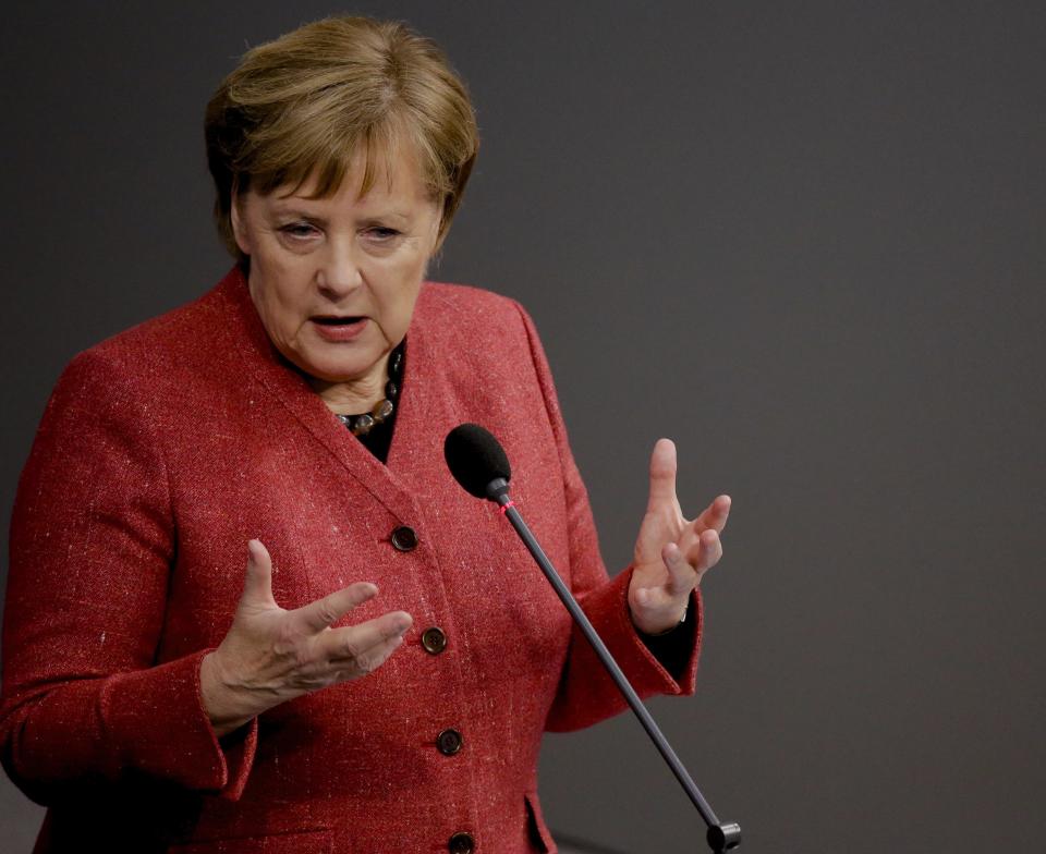 German Chancellor Angela Merkel answers questions of lawmakers during a parliament session of the Bundestag in Berlin, Wednesday, Dec. 12, 2018. (AP Photo/Markus Schreiber)