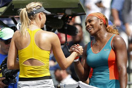 Mar 27, 2014; Miami, FL, USA; Serena Williams (right) shakes hands with Maria Sharapova (left) after their match on day eleven of the Sony Open at Crandon Tennis Center. Wiliams won 6-4, 6-3. Geoff Burke-USA TODAY Sports