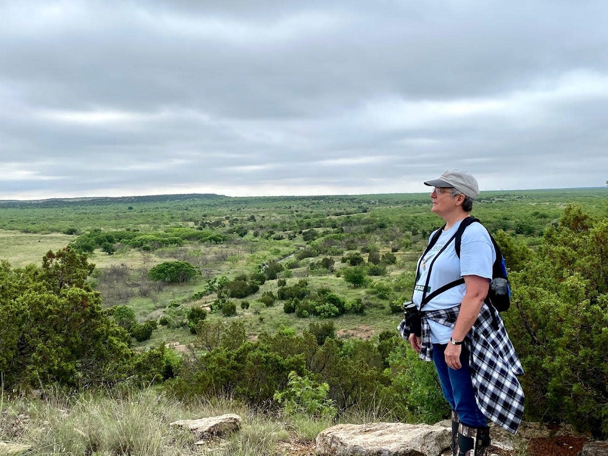 TMN Member Glenna Pickens standing on a hill.