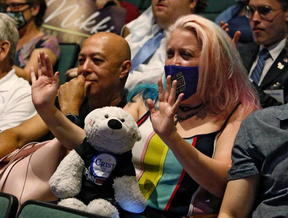 Charlie Crist supporter Kira Willig and her bear Jacob participate in the gubernatorial public forum hosted by the Miami-Dade Democratic Party on Saturday, May 28, 2022, at Julius Littman Performing Arts Theater in North Miami Beach.