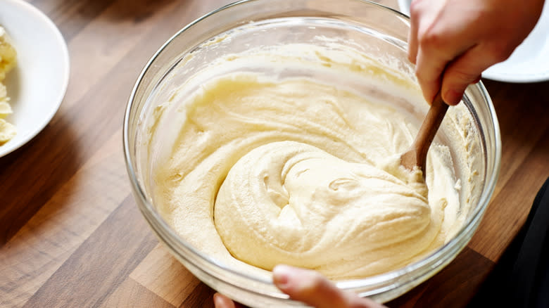 Hands mixing cake batter