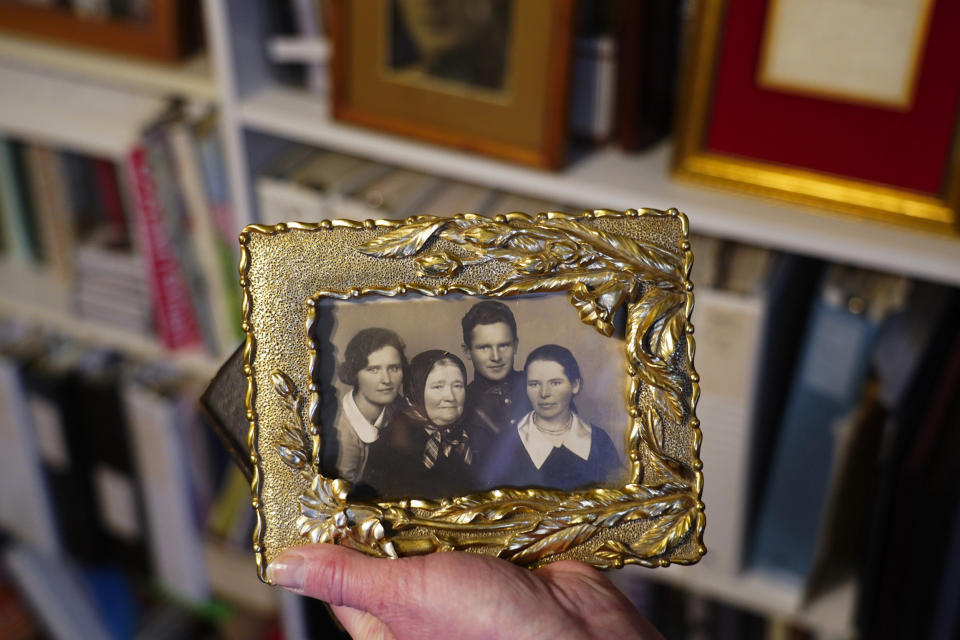 Image: Silvia Foti holds a photograph of her grandfather Jonas Noreika (Jose M. Osorio / Chicago Tribune via Getty Images)