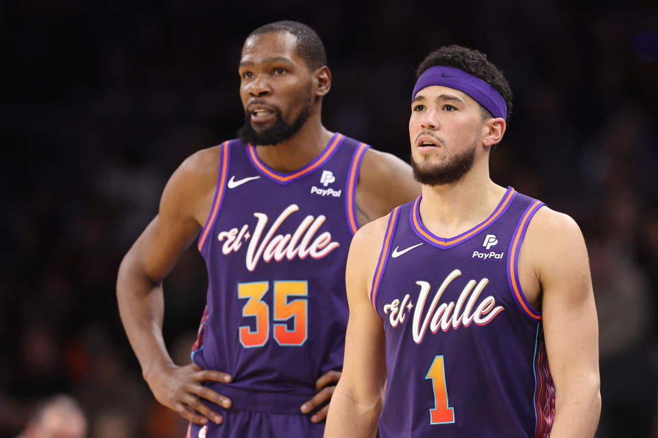 PHOENIX, ARIZONA - DECEMBER 29:  Devin Booker #1 and Kevin Durant #35 of the Phoenix Suns on the court during the first half of the NBA game against the Charlotte Hornets at Footprint Center on December 29, 2023 in Phoenix, Arizona. NOTE TO USER: User expressly acknowledges and agrees that, by downloading and or using this photograph, User is consenting to the terms and conditions of the Getty Images License Agreement.  (Photo by Christian Petersen/Getty Images)