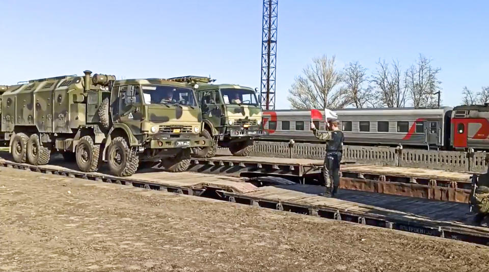 This handout photo taken from a video released on Friday, April 23, 2021 by Russian Defense Ministry Press Service shows, Russian military trucks are readied for loading after drills in Crimea. Russian Defense Minister Sergei Shoigu on Thursday ordered troops back to their permanent bases after a massive military buildup that caused Ukrainian and Western concerns. (Russian Defense Ministry Press Service via AP)