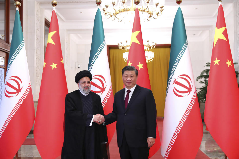 FILE - In this photo released by the official website of the office of the Iranian Presidency, President Ebrahim Raisi, left, shakes hands with his Chinese counterpart Xi Jinping in an official welcoming ceremony in Beijing, Tuesday, Feb. 14, 2023. Iran and Saudi Arabia have agreed to reestablish diplomatic relations and reopen embassies after years of tensions. The two countries released a joint communique about the deal on Friday, March 10, 2023 with China, which apparently brokered the agreement. (Iranian Presidency Office via AP, File)