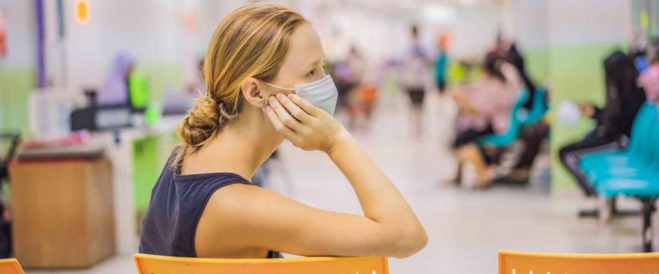 Coronavirus in the hospital covid 19. Woman in a medical mask Patients In Doctors Waiting Room