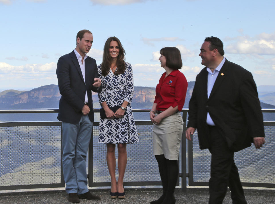 Britain's Prince William, left, and his wife Kate, the Duchess of Cambridge, second left, stand with Randall Walker, right, chief executive officer of Blue Mountains Lithgow and Oberon Tourism and Anthea Hammon, joint managing director of Scenic World at Echo Point Lookout in Katoomba, Australia, Thursday, April 17, 2014. The Duke and Duchess of Cambridge on Thursday stopped in the Blue Mountains town of Winmalee to meet with firefighters and locals affected by last year's wildfires that destroyed more than 200 homes. (AP Photo/Rob Griffith)