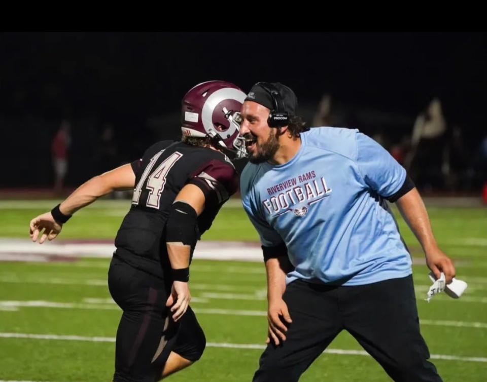 Riverview's Anthony Miller passes Ram wide receivers coach Nick Ortiz after Miller caught one of his two touchdown passes Friday night against Southeast. Miller also threw a touchdown.