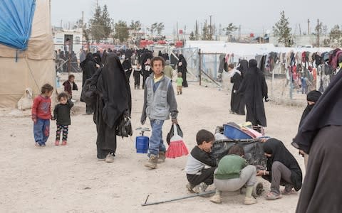 Women and children walk through the section for foreign families at a camp for people who lived under ISIS and are now displaced, in Al Hol, near Hasakeh in Syria - Credit: Sam Tarling/The Telegraph