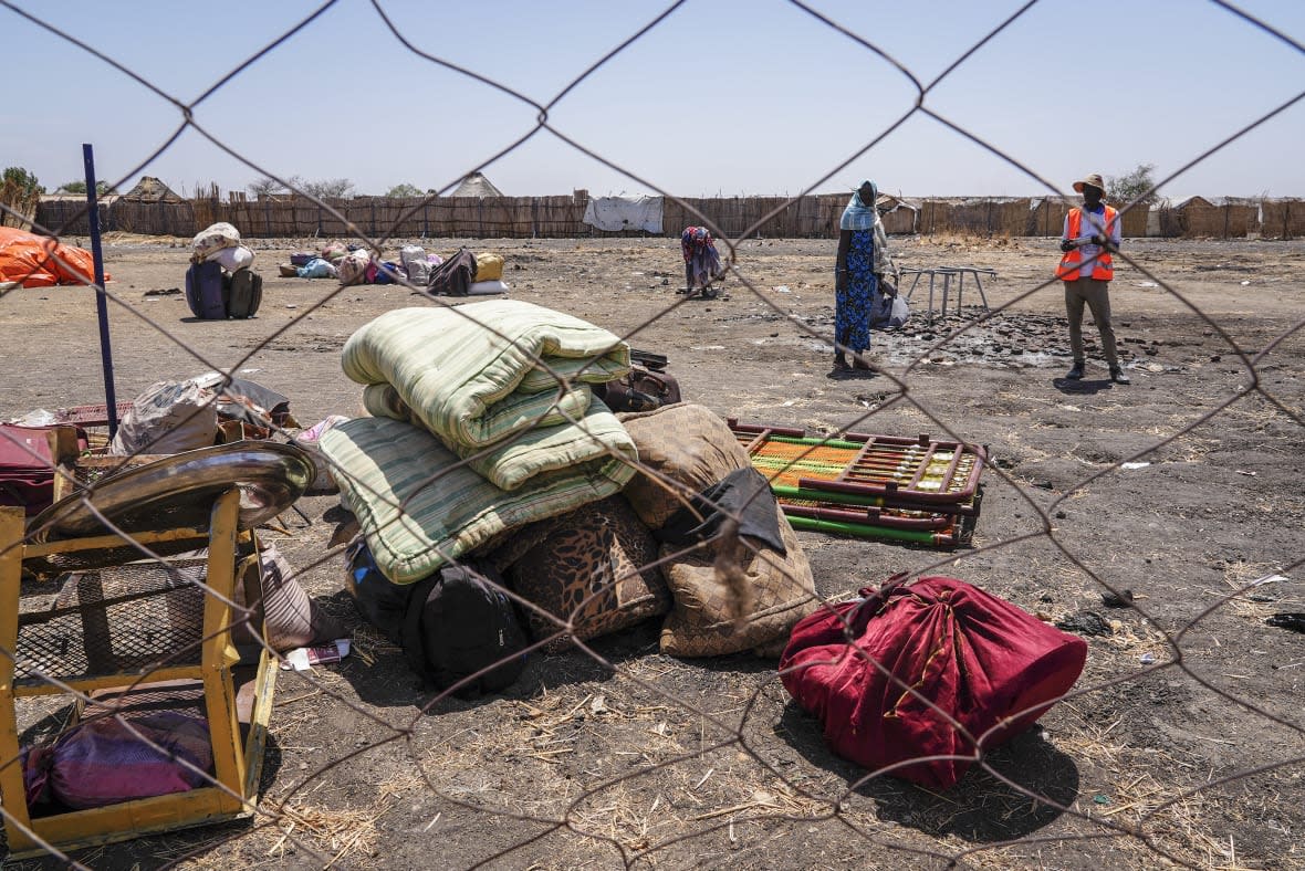 The belongings of people who crossed the border from Sudan sit in a yard at the Joda border crossing in South Sudan Tuesday, May 16, 2023. Tens of thousands of South Sudanese are flocking home from neighboring Sudan, which erupted in violence last month. (AP Photo/Sam Mednick)