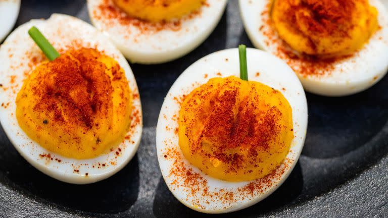 <p>These pumpkin devilled eggs are way easier to make than a jack-o'-lantern. Paprika gives each its bold colour, while a fresh chive makes for the perfect stem.</p><p>Get the <a href="https://www.delish.com/uk/cooking/recipes/a33978223/pumpkin-deviled-eggs-recipe/" rel="nofollow noopener" target="_blank" data-ylk="slk:Pumpkin Devilled Eggs;elm:context_link;itc:0;sec:content-canvas" class="link ">Pumpkin Devilled Eggs</a> recipe.</p>