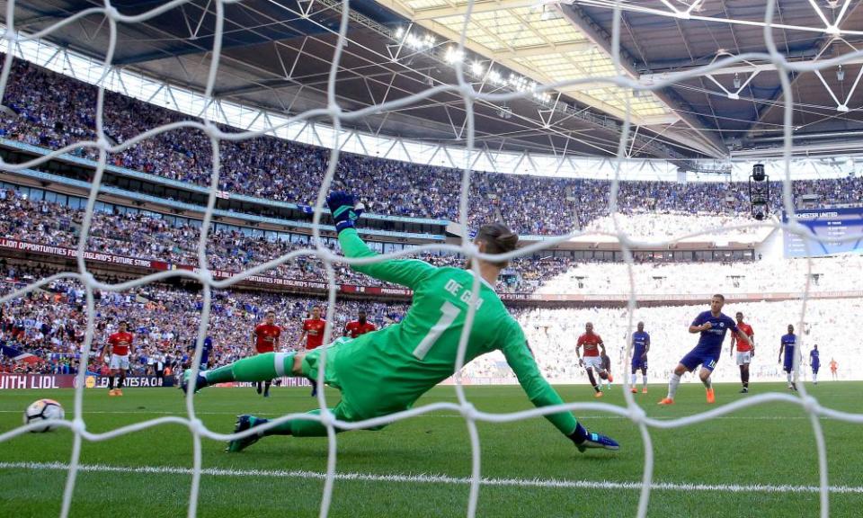 Eden Hazard tucks away the winning goal from the penalty spot after he was brought down by Phil Jones.