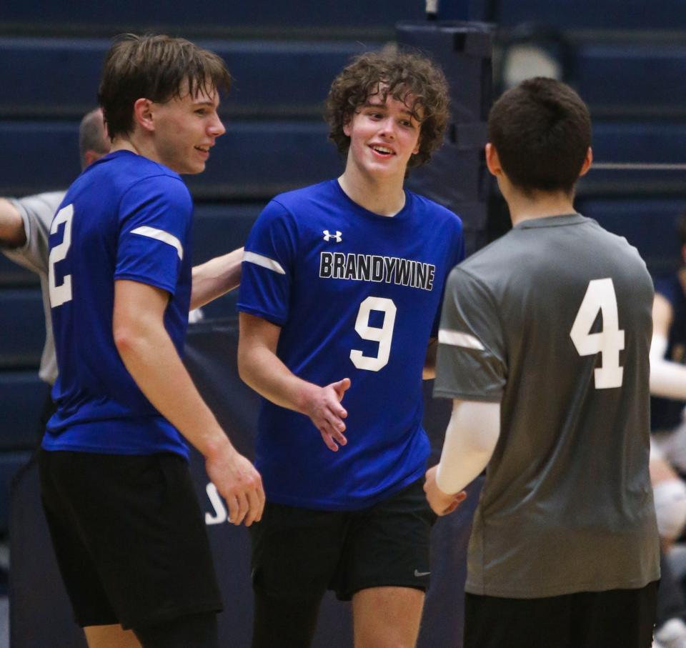 Brandywine's Charles Hearn (2), Brody Haas (9) and Felipe Pena enjoy a point in the second set as the Bulldogs pull off a 3-2 upset in the opening round of the DIAA state high school tournament at Delaware Military Academy, Wednesday, May 15, 2024.