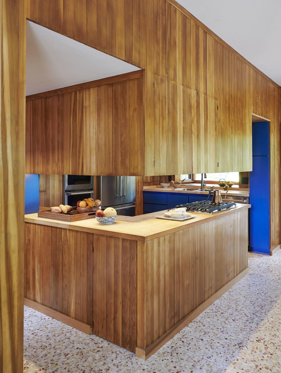 Terrazzo floors and cedar paneling make a statement in the kitchen.