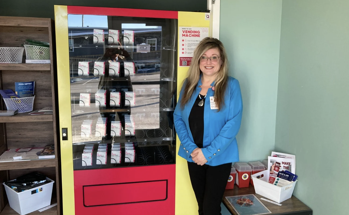 Mi'kmaq Nation Health Director Katie Espling with the tribe's new vending machine that holds 300 doses of opioid reversal drug Nalaxone. (courtesy photo)