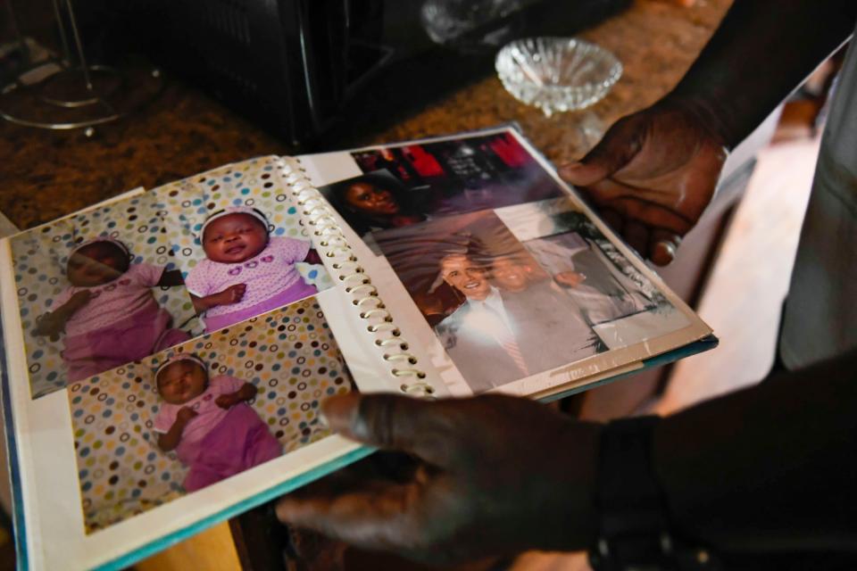 Henry Thomas shows an old family photo album he found inside his grandmother's house, where he was born and raised, in Walterboro, S.C., on Saturday, July 1, 2023.
