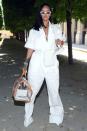 <p>In a white utilitarian wide leg jumpsuit (from <a href="https://www.harpersbazaar.com/fashion/designers/a21750168/rihanna-virgil-abloh-louis-vuitton/" rel="nofollow noopener" target="_blank" data-ylk="slk:Virgil Abloh's debut Louis Vuttion collection;elm:context_link;itc:0;sec:content-canvas" class="link ">Virgil Abloh's debut Louis Vuttion collection</a>), a pair of killer pumps, angular sunglasses and not one, but three bags for the Vuitton show in Paris. <br></p>