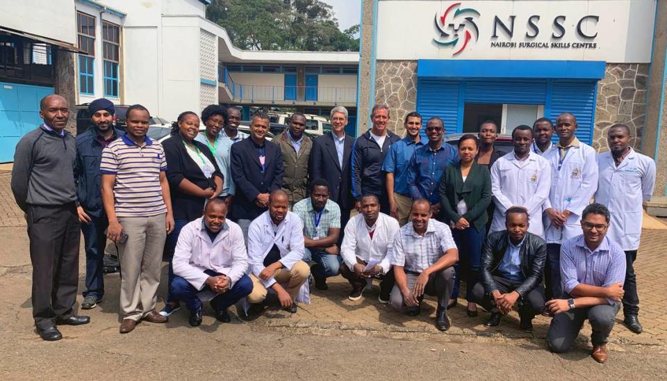 Dr. Leland McCluskey, standing center, and other participants in a Steps2Walk, Inc. in Kenya pose for a group photo.