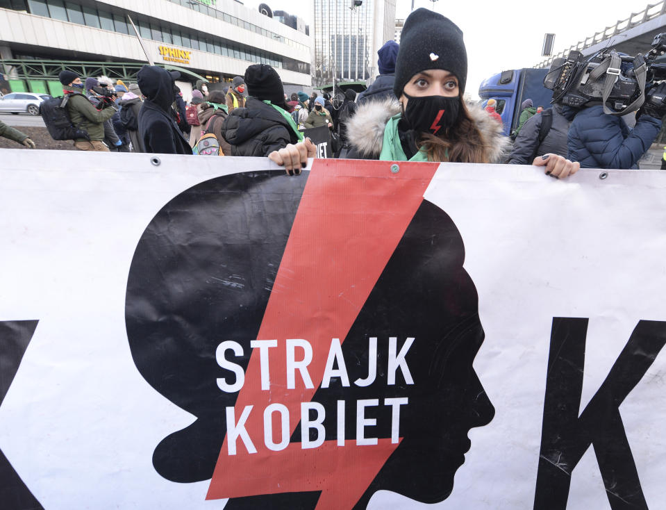 People join a protest on International Women's Day in Warsaw, Poland, Monday March 8, 2021. Women’s rights activists in Poland marked International Women’s Day on Monday caught between reasons to celebrate and a heavy sense that they are facing a long battle ahead. This year’s Women’s Day, which is being marked with protests, comes after a near total ban on abortion took effect in January in the historically Roman Catholic country, a step that had long been been sought by the conservative ruling party, Law and Justice. (AP Photo/Czarek Sokolowski)