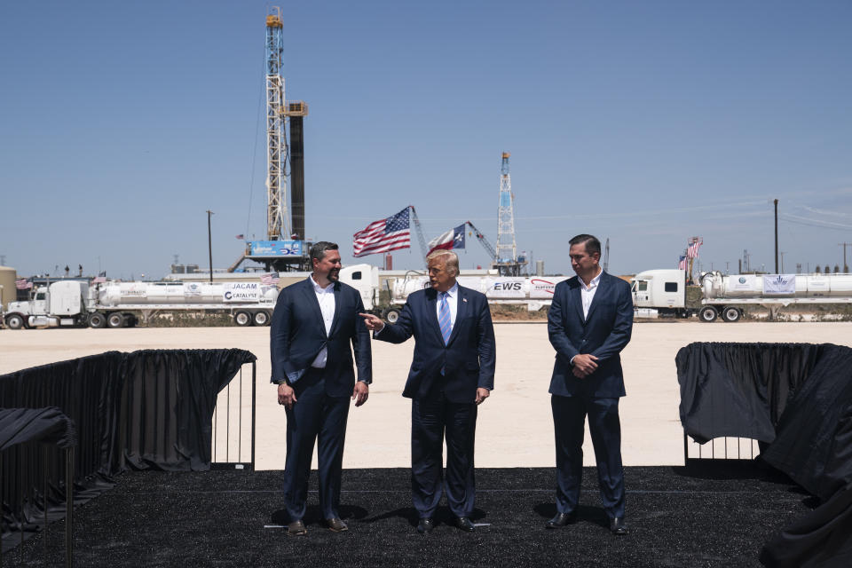 President Donald Trump stands with Double Eagle Energy co-CEOs Cody Campbell, left, and John Sellers, right, as he arrives at the Double Eagle Energy Oil Rig, Wednesday, July 29, 2020, in Midland, Texas. (AP Photo/Evan Vucci)