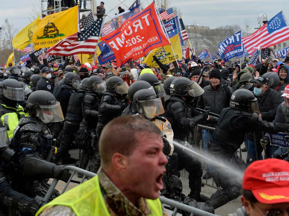 Trump supporters clash with police and security forces as people try to storm the US Capitol in Washington DC on 6 January 2021 (AFP via Getty Images)