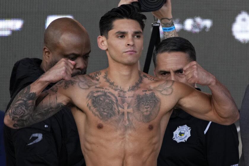 Ryan Garcia poses on the scale during a weigh-in Friday, April 21, 2023, in Las Vegas. Garcia is scheduled to fight Gervonta Davis in a catchweight boxing bout in Las Vegas on Saturday. (AP Photo/John Locher)