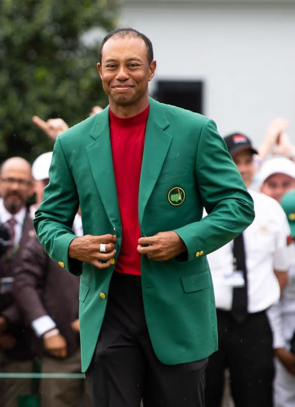 Tiger Woods tries on his Green Jacket after winning the 2019 Masters Tournament at Augusta National Golf Club in Augusta, Ga., on April 14, 2019. On April 13, 1997, Woods, 21, won his first Masters, the youngest golfer to accomplish that feat. File Photo by Kevin Dietsch/UPI