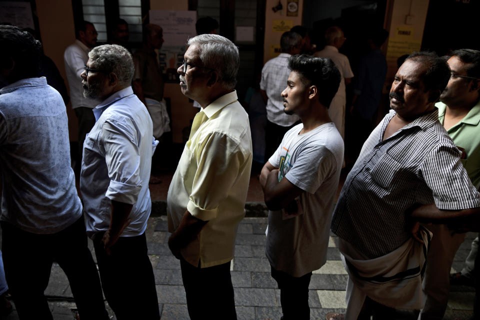 People queue up to vote during the second round of voting in the six-week long national election outside a polling booth in Kochi, southern Kerala state, India, Friday, April 26, 2024. (AP Photo/R S Iyer)