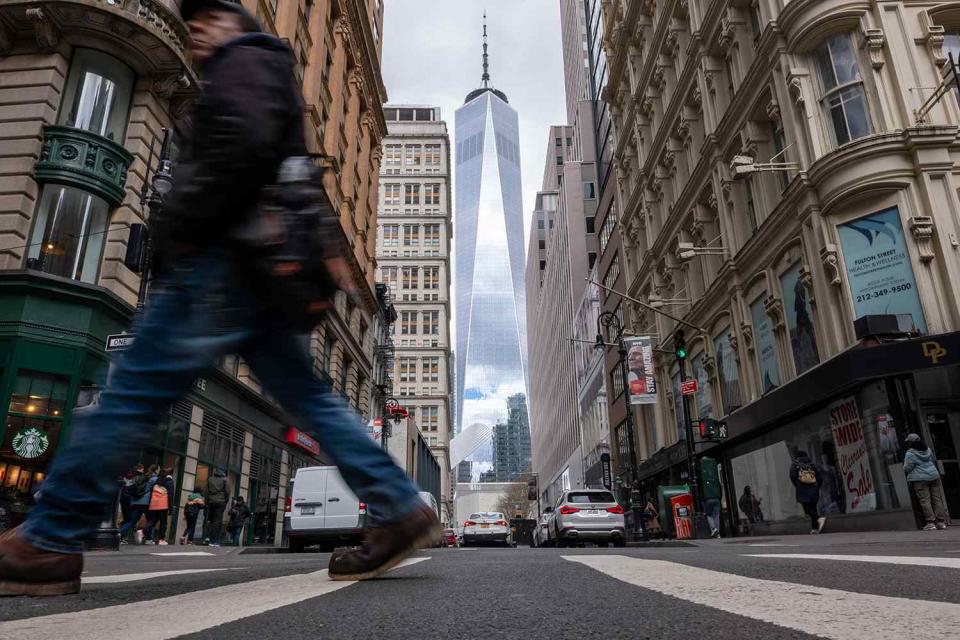 <p>Spencer Platt/Getty Images</p> People walk through lower Manhattan moments after New York City and parts of New Jersey experienced a 4.8 magnitude earthquake on April 5
