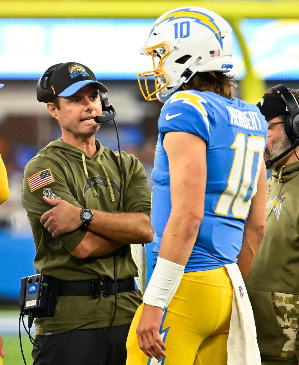 Los Angeles Chargers head coach Brandon Staley talks to quarterback Justin Herbert during a game this season.