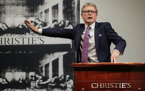 Auctioneer Jussi Pylkkanen takes bids at the auction of Leonardo da Vinci's "Salvator Mundi" during the Post-War and Contemporary Art evening sale at Christie's on November 15, 2017 - Credit: Getty