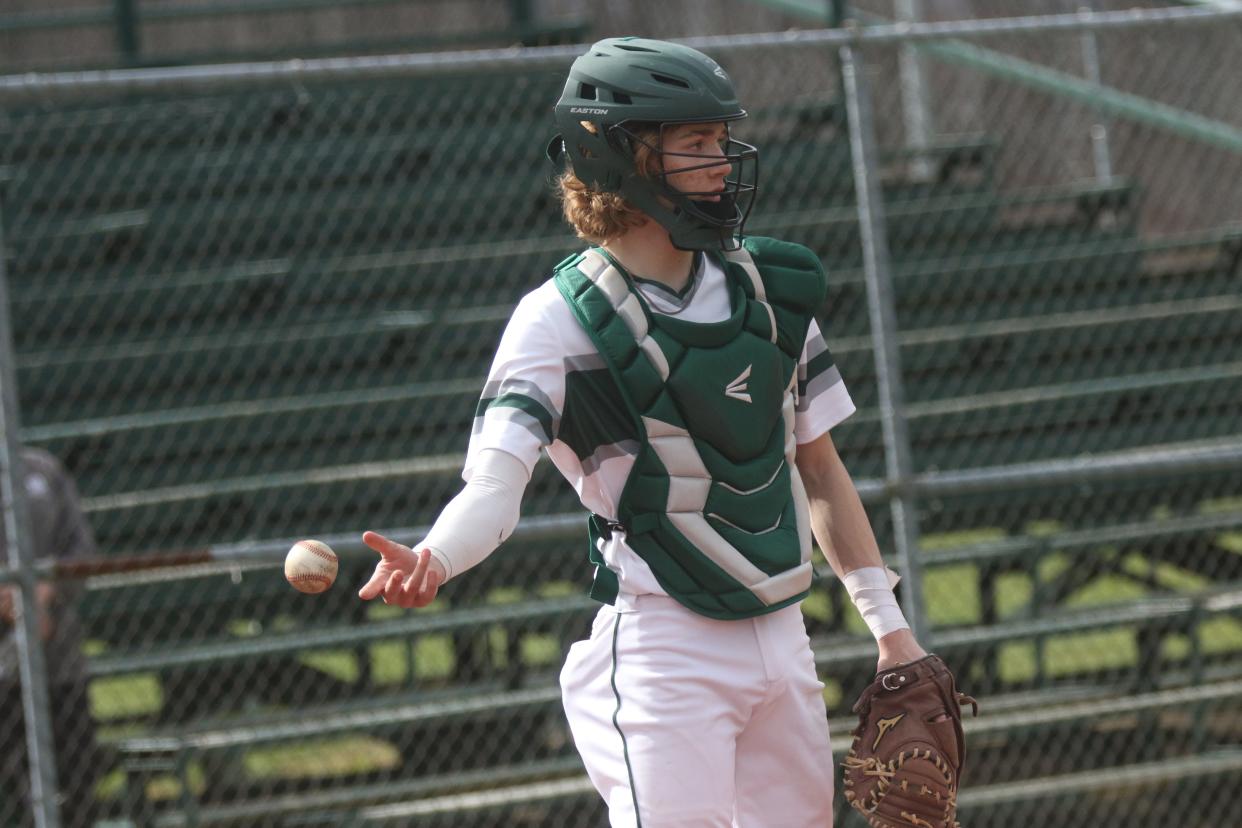 Madison's Cameron Kuhn tosses a ball to a coach during infield warmups before a game against Ontario last spring.