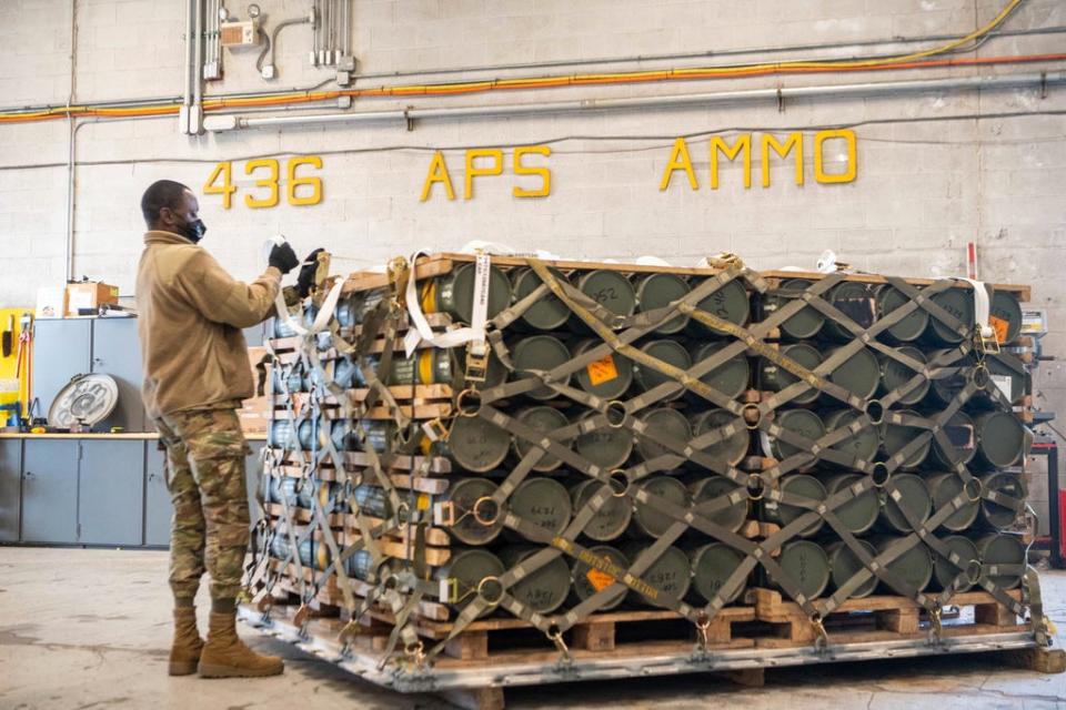 Airmen and civilians from the US army’s 436th Aerial Port Squadron palletize ammunition, weapons and other equipment bound for Ukraine (AP)