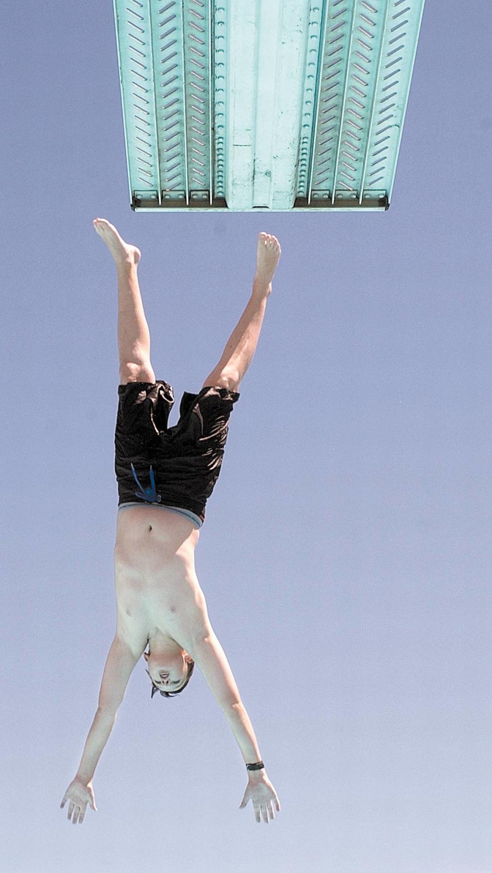 Colton Hall of Templeton takes a dive off the high board at the Atascadero High School pool. Hot weather has kids flocking to pools all over San Luis Obispo County.