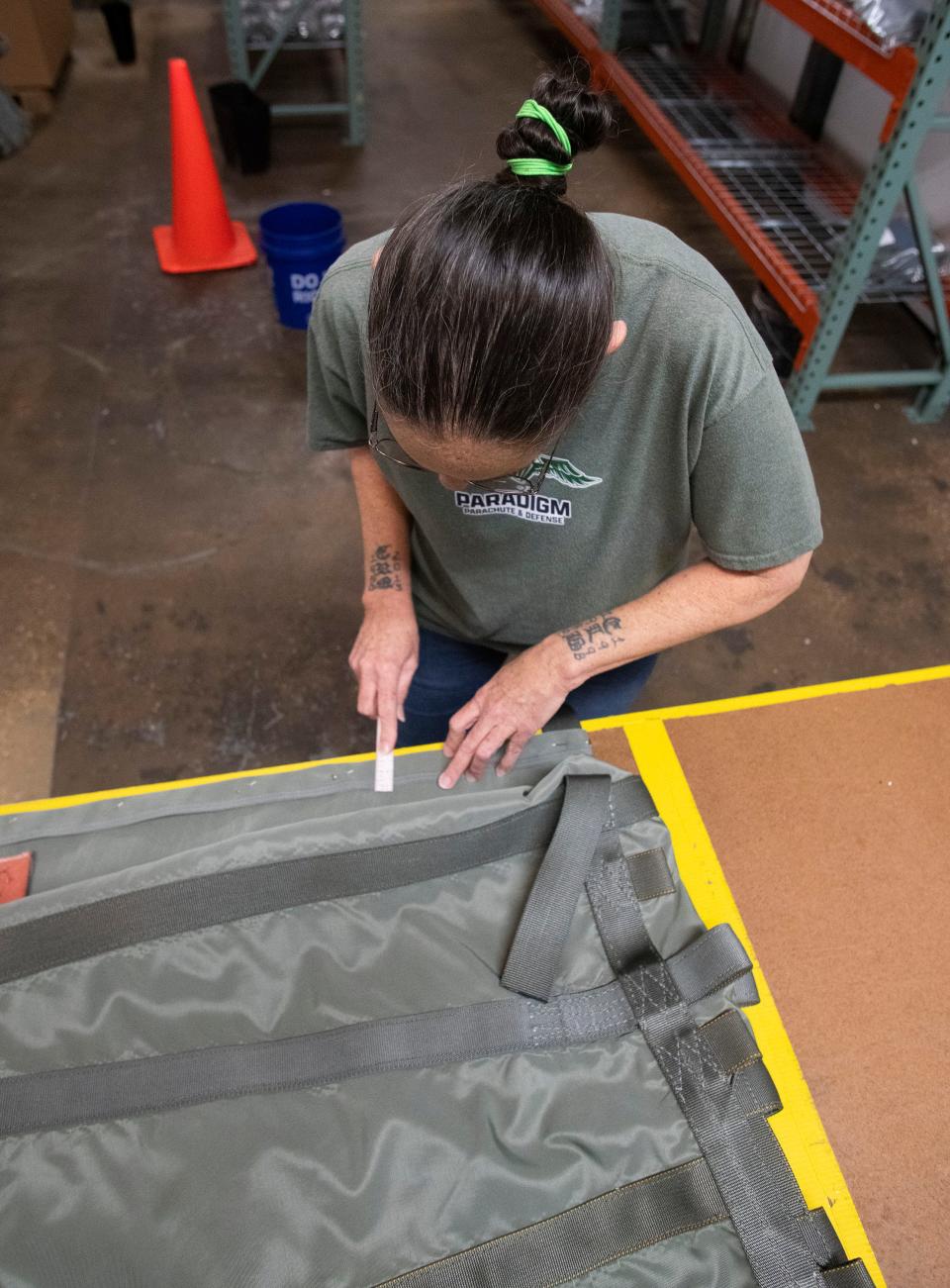 Paradigm Parachute and Defense employee Cary Smothers ensures the quality of products at the company's facility in Escambia County on Nov. 7.