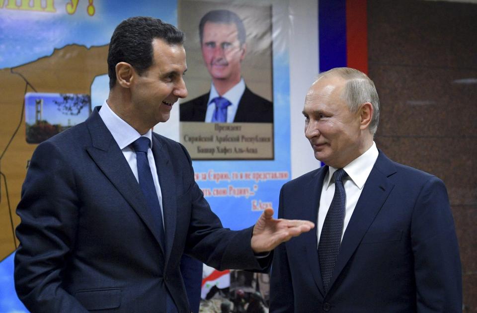 FILE - Syrian President Bashar Assad, left, gestures while speaking to Russian President Vladimir Putin during their meeting in Damascus, Syria, Tuesday, Jan. 7, 2020. With its war on Ukraine now in its third week, Putin on Friday, March 11, 2022, approved bringing in volunteer fighters from the Middle East into the conflict. (Alexei Druzhinin, Sputnik, Kremlin Pool Photo via AP, File)