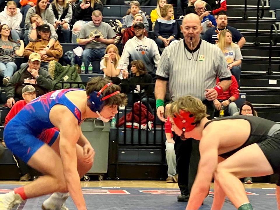 Pleasant's Daxton Chase, right, faces off with Highland's Matthew Scarberry in the 144-pound championship match at the Mid Ohio Athletic Conference Wrestling Tournament Saturday at Galion.