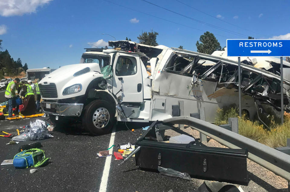 FILE - This Friday, Sept. 20, 2019, file photo released by the Garfield County Sheriff's Office shows a tour bus that was carrying Chinese-speaking tourists after it crashed near Bryce Canyon National Park in southern Utah, killing at least four people and critically injuring up to 15 others. The families of Chinese tourists killed or injured in a 2019 tour bus crash say the state's design and maintenance failed to keep the remote highway safe. More than a dozen people were thrown from the bus when the driver drifted off the road and overcorrected when he steered back, sending the bus into a rollover. A lawsuit alleges the state failed to post warning signs, had a road design that left little room for error and included no rumble strip to warn drivers. The NTSB investigation found a lack of safety standards for bus roofs and windows contributed to death and injury toll. Its final report, released in June, also cited inconsistent seat belt use and recommended a lane-departure warning system for commercial buses. (Sheriff Danny Perkins/Garfield County Sheriff's Office via AP, File)