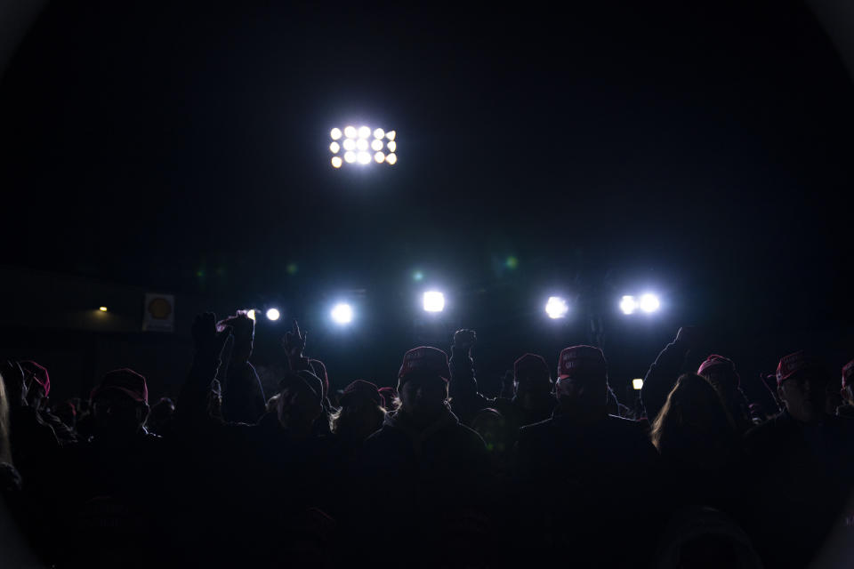FILE - In this Oct. 24, 2020, file photo supporters of President Donald Trump listen to him speak a campaign rally at Waukesha County Airport in Waukesha, Wis. (AP Photo/Evan Vucci, File)