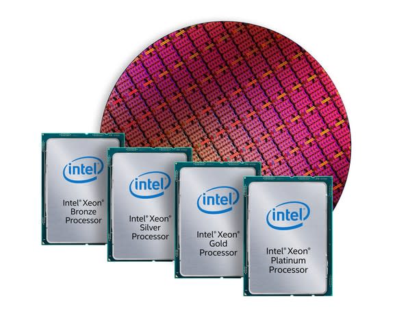 A wafer of Intel chips in the background with fully packaged chips in the foreground.