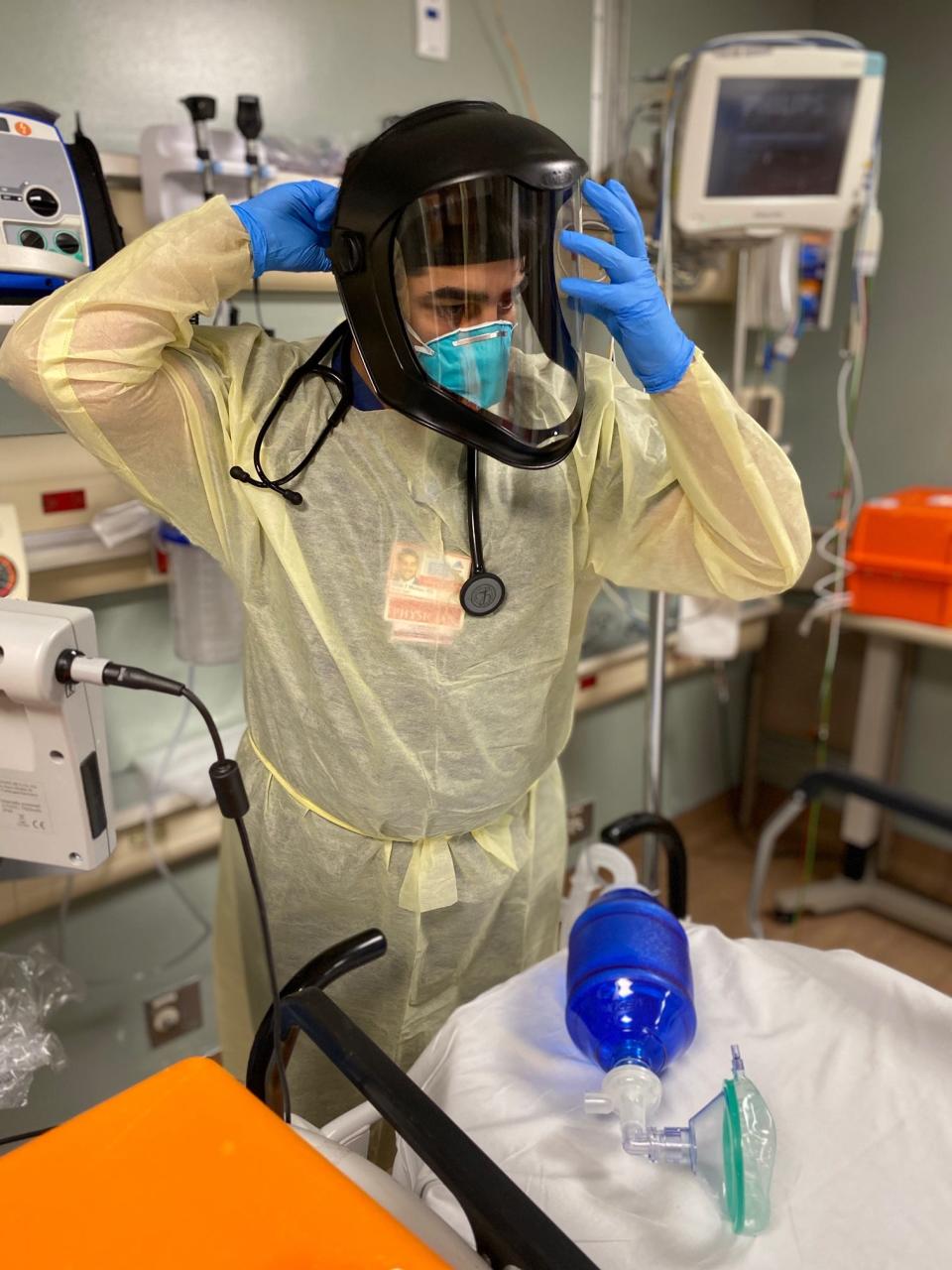 Omar Maniya, an emergency medicine resident, gears up for another shift at Mount Sinai Hospital in Manhattan. He has treated nearly 200 COVID-19 patients and came down with the virus himself in early March.