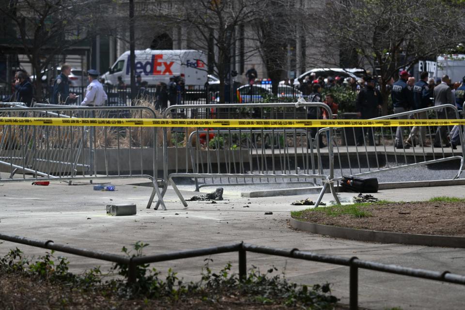 Police crime tape is strung at the site across from Manhattan Criminal Court in New York City after a man reportedly set himself on fire during the trial of former President Donald Trump, in New York City on April 19, 2024. A man set himself on fire Friday outside the court, New York police said, with officers rushing to extinguish the flames. TV reporters described the scene that unfolded moments after the full panel of 12 jurors and six alternates was selected for the trial of the former president in a hush money cover-up case.