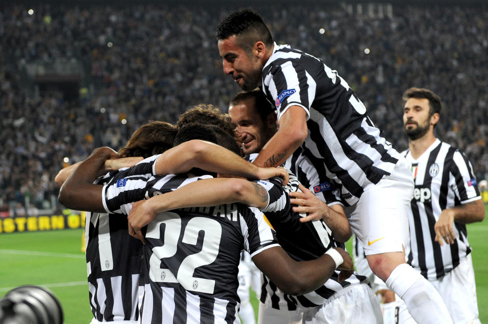 Juventus players celebrates after Andrea Pirlo scored during the Europa League quarterfinal soccer match between Juventus and Olympic Lyon at the Juventus stadium, in Turin, Italy, Thursday, April 10, 2014. (AP Photo/ Massimo Pinca)